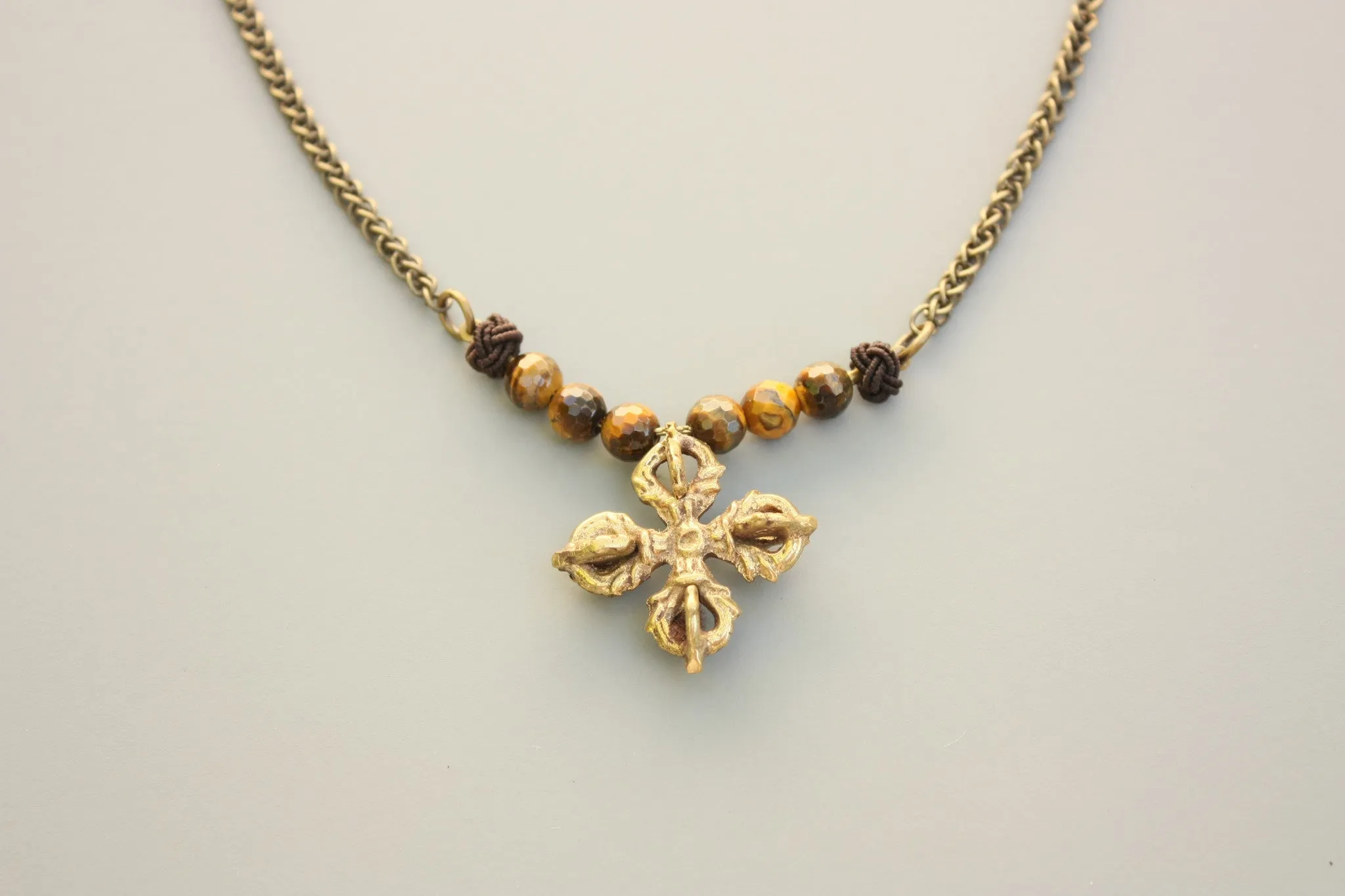 Javitri Faceted Tiger eye and Brass Buddhist cross Necklace